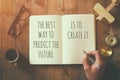 Open notebook over wooden table with motivational saying