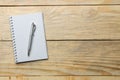 Open notebook and pen on the natural wooden table. top view. office tools Royalty Free Stock Photo