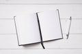 Open notebook and pen on white wooden desk Royalty Free Stock Photo