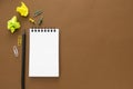 Open notebook, pencil isolated on brown background. Education, freelance, office supplies. Copy space Royalty Free Stock Photo