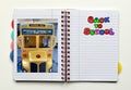 Open notebook with a photo of a school bus. Space for text. Back to school concept Royalty Free Stock Photo