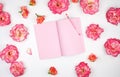 open notebook with pink blank pages on a white background and petals of a pink roses Royalty Free Stock Photo