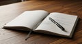 An open notebook is placed on a wood-grain table. The pages appear white, with handwritten notes on Royalty Free Stock Photo