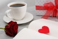Open notebook with red heart, coffee and rose flower on light grey table. Valentine`s day celebration Royalty Free Stock Photo