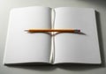Open notebook resting on a flat surface, its blank white pages laid open. A sharpened Royalty Free Stock Photo