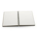 Open notebook with a spiral binding lies flat on a white surface. The notebook has blank, white Royalty Free Stock Photo