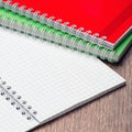 An open notebook on the table and two Notepad Royalty Free Stock Photo