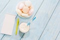 Open notebook, white mug with coffee, marshmallows.