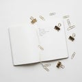 Open notebook with a white ribbon bookmark placed on a white surface Royalty Free Stock Photo