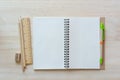 Open notebook on wooden background with pencils and ruler. Royalty Free Stock Photo