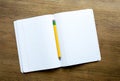 Open notebook with yellow pencil on a desk Royalty Free Stock Photo