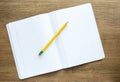 Open notebook with yellow pencil on a desk Royalty Free Stock Photo