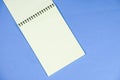 Open notepad on a blue background top view, space for text. Royalty Free Stock Photo