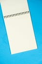 Open notepad on a blue background top view, space for text. Royalty Free Stock Photo