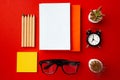 Open notepad with color pencils and flower pots on red background Royalty Free Stock Photo