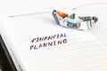 Open notepad with the handwriting text FINANCIAL PLANNING and th