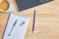 an open notepad for notes, a fountain pen, a pencil , a cup of coffee and a laptop on a wooden table with a copy space Royalty Free Stock Photo