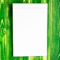 Open notepad for sign and sketches on a bright green wooden background