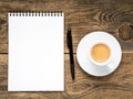 open notepad with spiral, pen and coffee cup on old wooden table Royalty Free Stock Photo