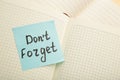 Open notepad and sticky notes with word don`t forget Royalty Free Stock Photo