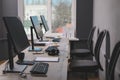 Open office interior. Modern workplaces with computers near window