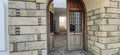 Open old arch door in house with stairs on background. Doorway beautiful stonework Royalty Free Stock Photo