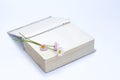 Open old book. Bouquet of flowers from daisies. View from above. on white background. Place for text. Royalty Free Stock Photo