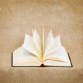 Open Old Book On Brown Canvas Background