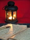 An open old book by the candlelight