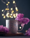 An open old book of fairy tales, a bouquet of lilacs and a cup of coffee or tea. Read an interesting book in the evening Royalty Free Stock Photo