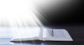 Open old book holy bible. magical Light falls on the book in the dark. Royalty Free Stock Photo