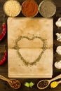 Open old vintage book with spices and heart on wooden background. Healthy vegetarian food. Royalty Free Stock Photo