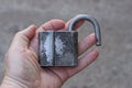 An open one old big gray padlock