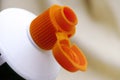 Open orange cap of toothpaste tube Royalty Free Stock Photo