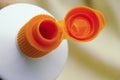 Open orange cap of toothpaste tube Royalty Free Stock Photo