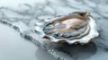 Open oyster shell with water droplets on a marble surface