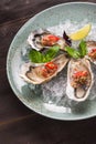 Open oyster stuffed with papper and lemon Royalty Free Stock Photo