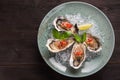 Open oyster stuffed with papper and lemon Royalty Free Stock Photo