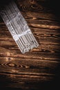 Open pack of welding electrodes on a wooden background. Studio photo in hard light