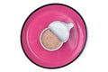 Open package of wet pet food on pink plate, seen directly from above. Royalty Free Stock Photo