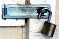 Open padlock on dirty shed door Royalty Free Stock Photo