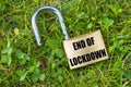Open padlock with `End of Lockdown` written in black Royalty Free Stock Photo