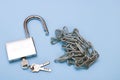open padlock with keys and chain on blue background Royalty Free Stock Photo