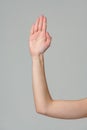 Open palm of a female hand o gray background Royalty Free Stock Photo