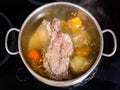 Open pan with cooking beef broth