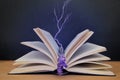 Open paper book with magic glow and lightning, concept of magic, on a wooden table, a sprig of lavender lavender instead of a