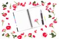 Open paper notebook, pen and rose on white background. Flat lay, top view Royalty Free Stock Photo