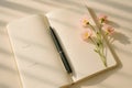 Open paper notepad with blank lines for planning on monday and pen with flowers Royalty Free Stock Photo