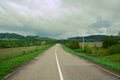 An open paved road leads into the distance.A dirt road in a forest thicket.the concept of Royalty Free Stock Photo