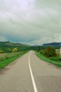 An open paved road leads into the distance.A dirt road in a forest thicket.the concept of Royalty Free Stock Photo